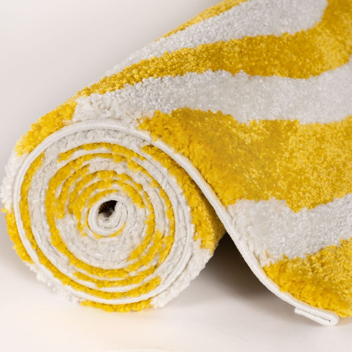 Roll of yellow and white striped fabric on a light background