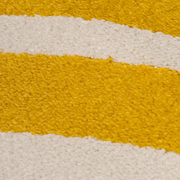 Close-up of a textured surface with yellow and white stripes