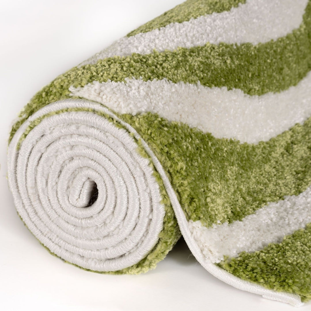 Rolled-up green and white striped rug on a white background