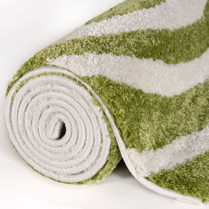 Rolled-up green and white striped rug on a white background