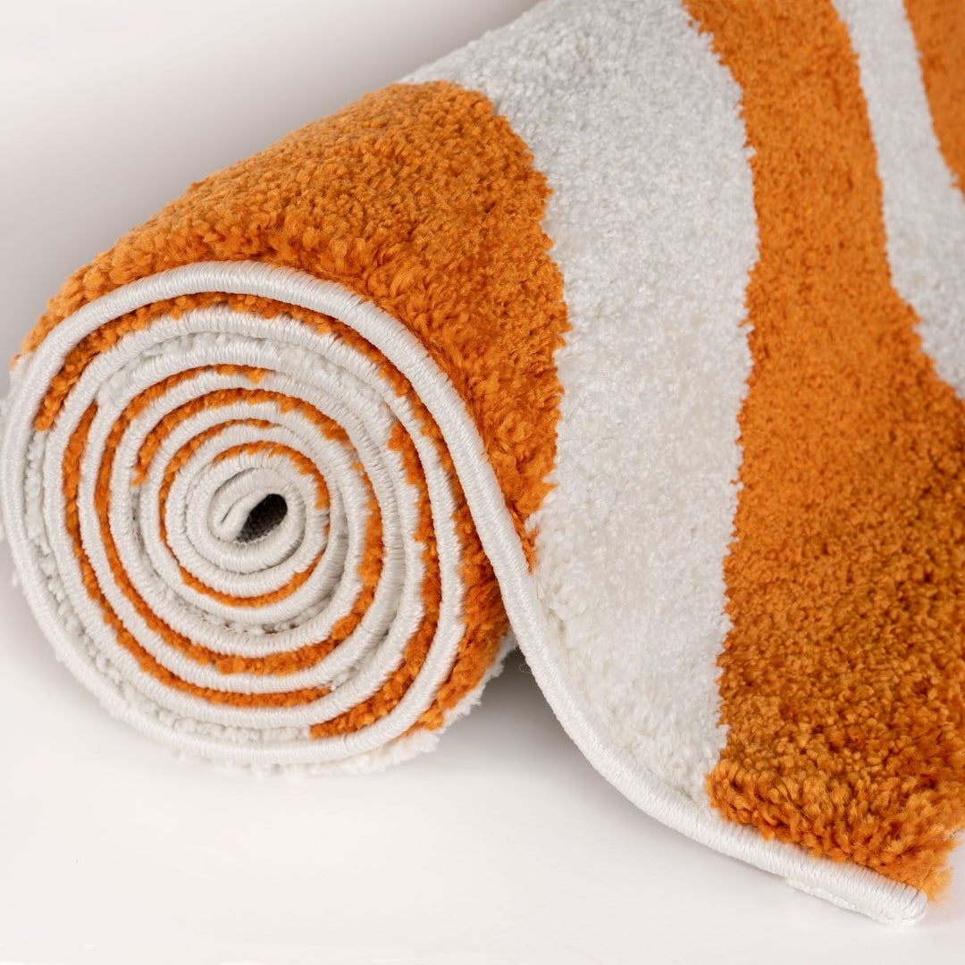 Roll of orange and white textured fabric on a light gray background