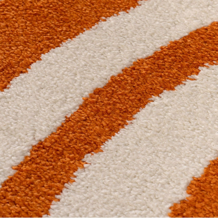 Close-up of a textured orange and white striped fabric