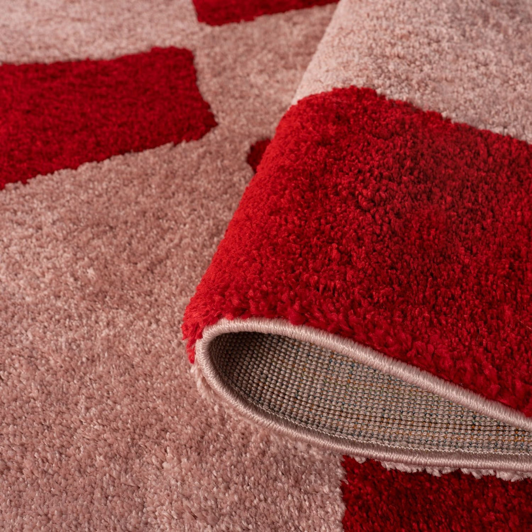Close-up of a red and beige patterned rug
