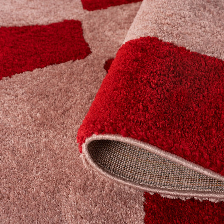 Close-up of a red and beige patterned rug