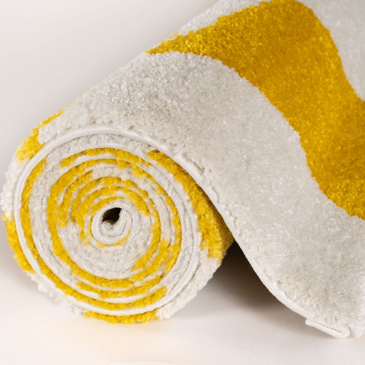 Roll of white and yellow fabric on a light background