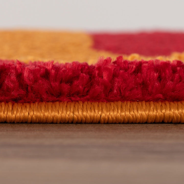 Close-up of red and gold striped fabric on a wooden surface