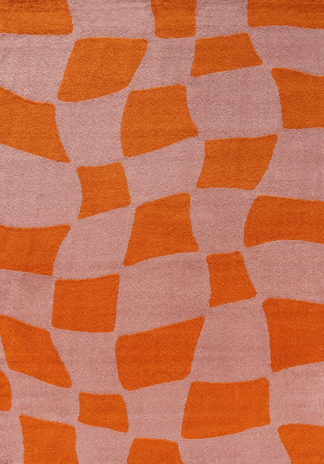 Patterned fabric with orange geometric shapes on a pink background
