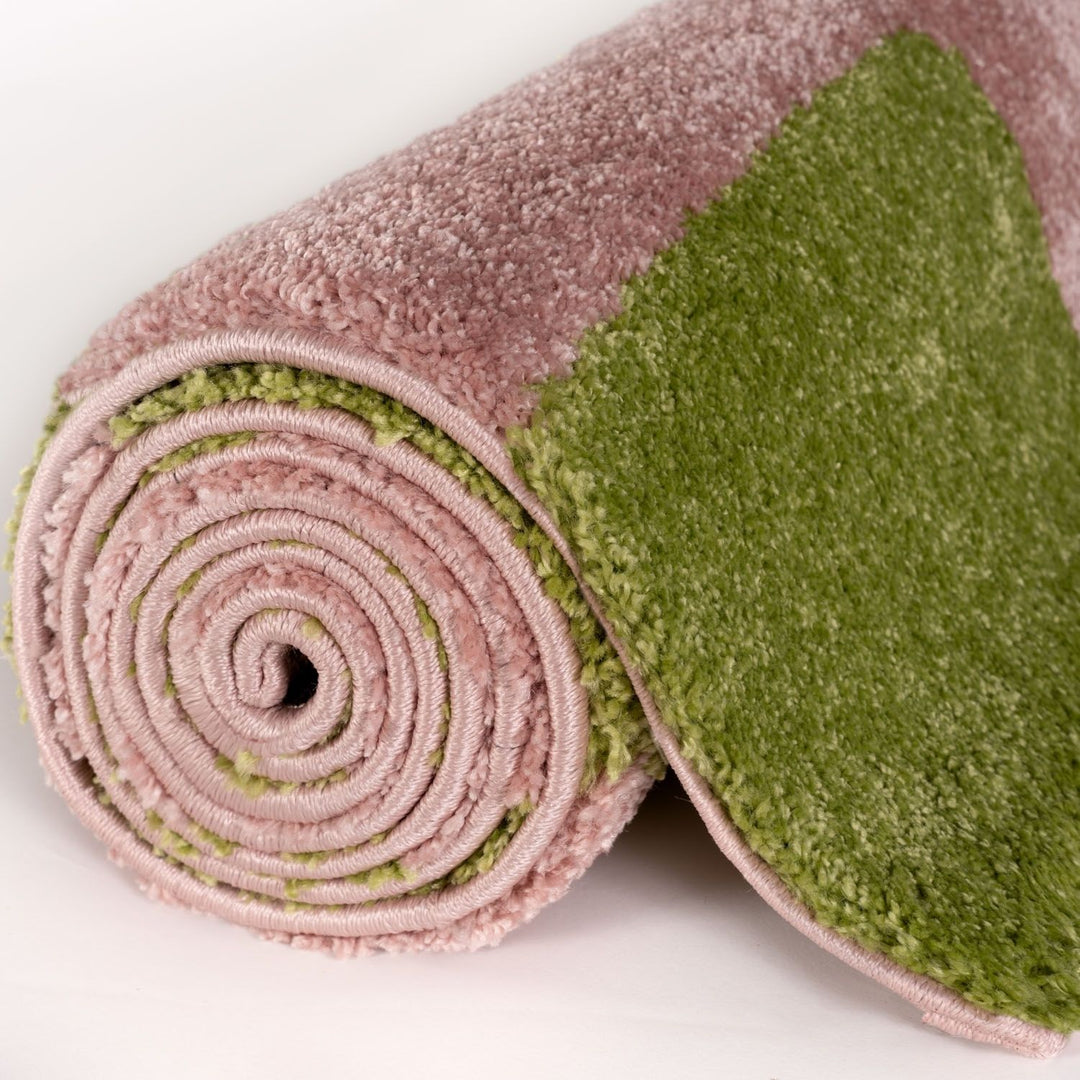Green and pink textured roll-up mat on a white background