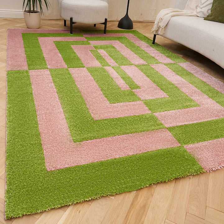 Geometric patterned rug with pink and green colors