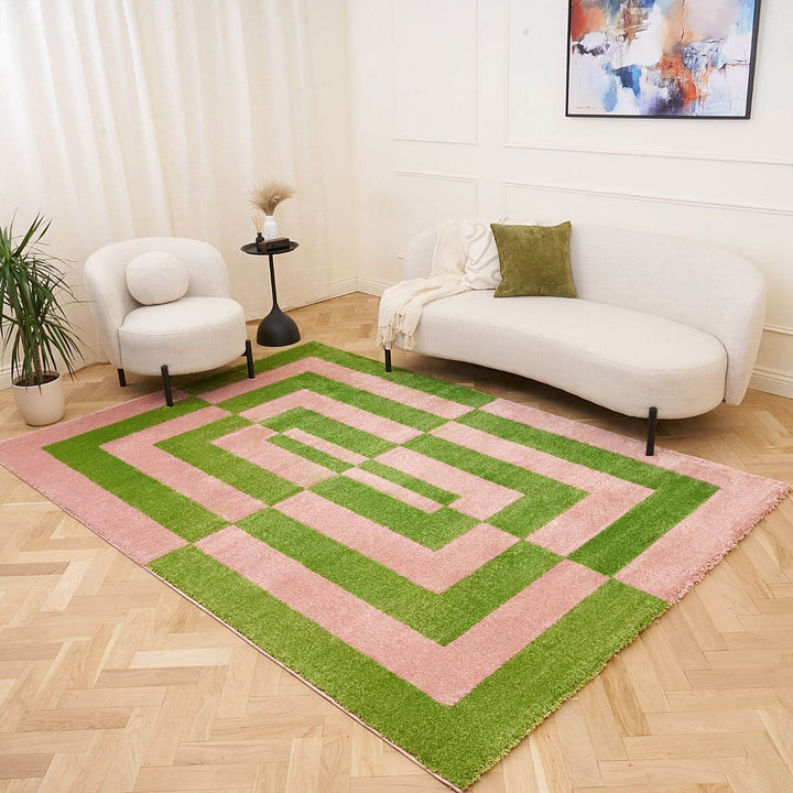 Geometric patterned rug with pink and green colors