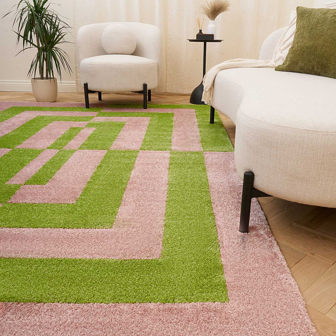 Geometric patterned rug with pink and green colors
