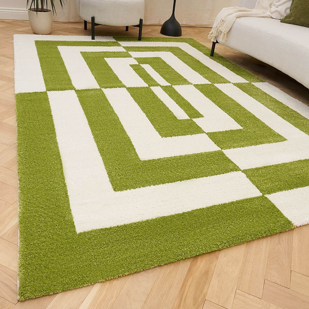 Green and white geometric patterned rug on a wooden floor
