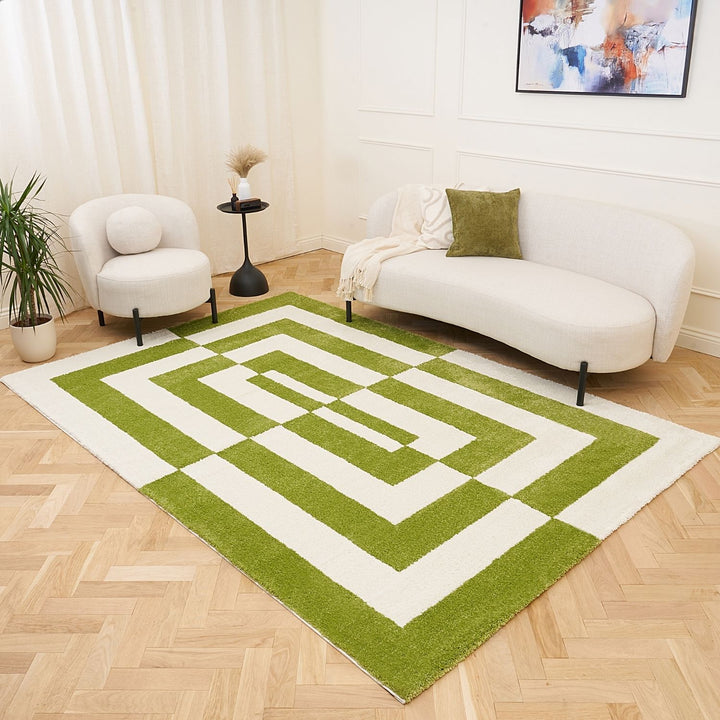 Green and white geometric rug in a living room with a sofa and chair.