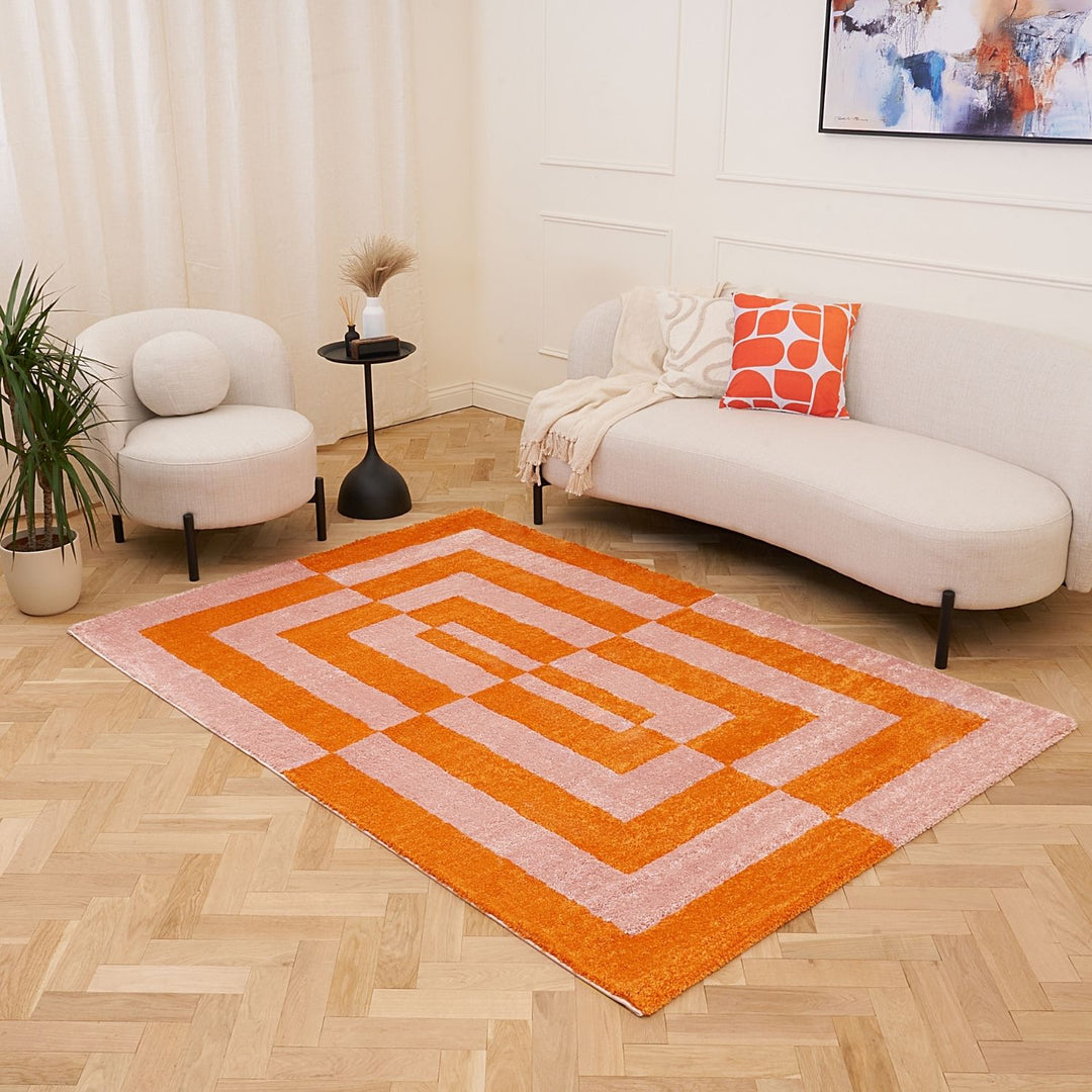 Living room with a geometric patterned rug, white sofa, and decorative items.