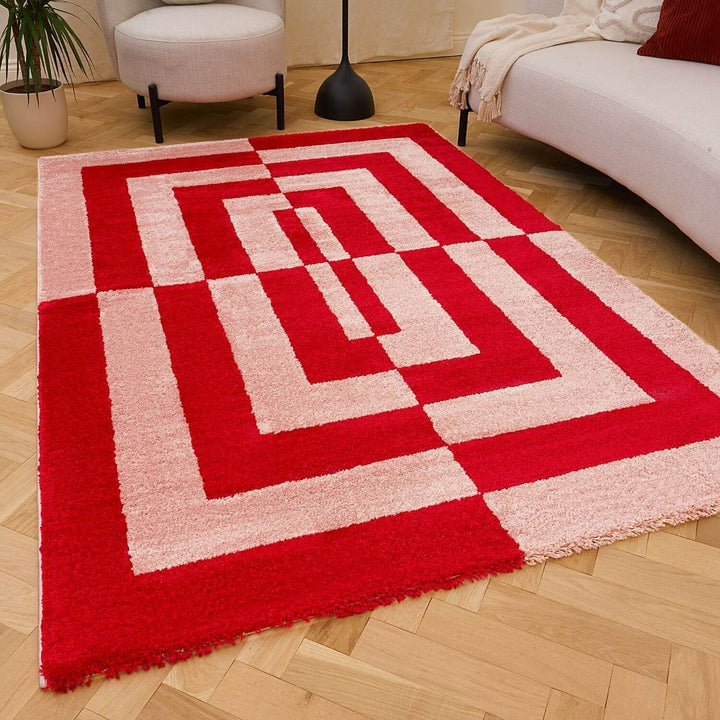 Red and white geometric patterned rug on a wooden floor