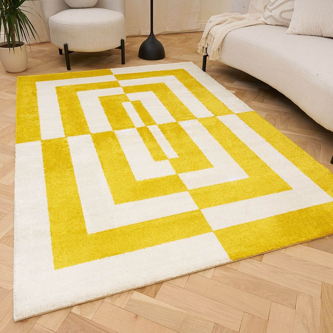 Yellow and white geometric patterned rug on a wooden floor