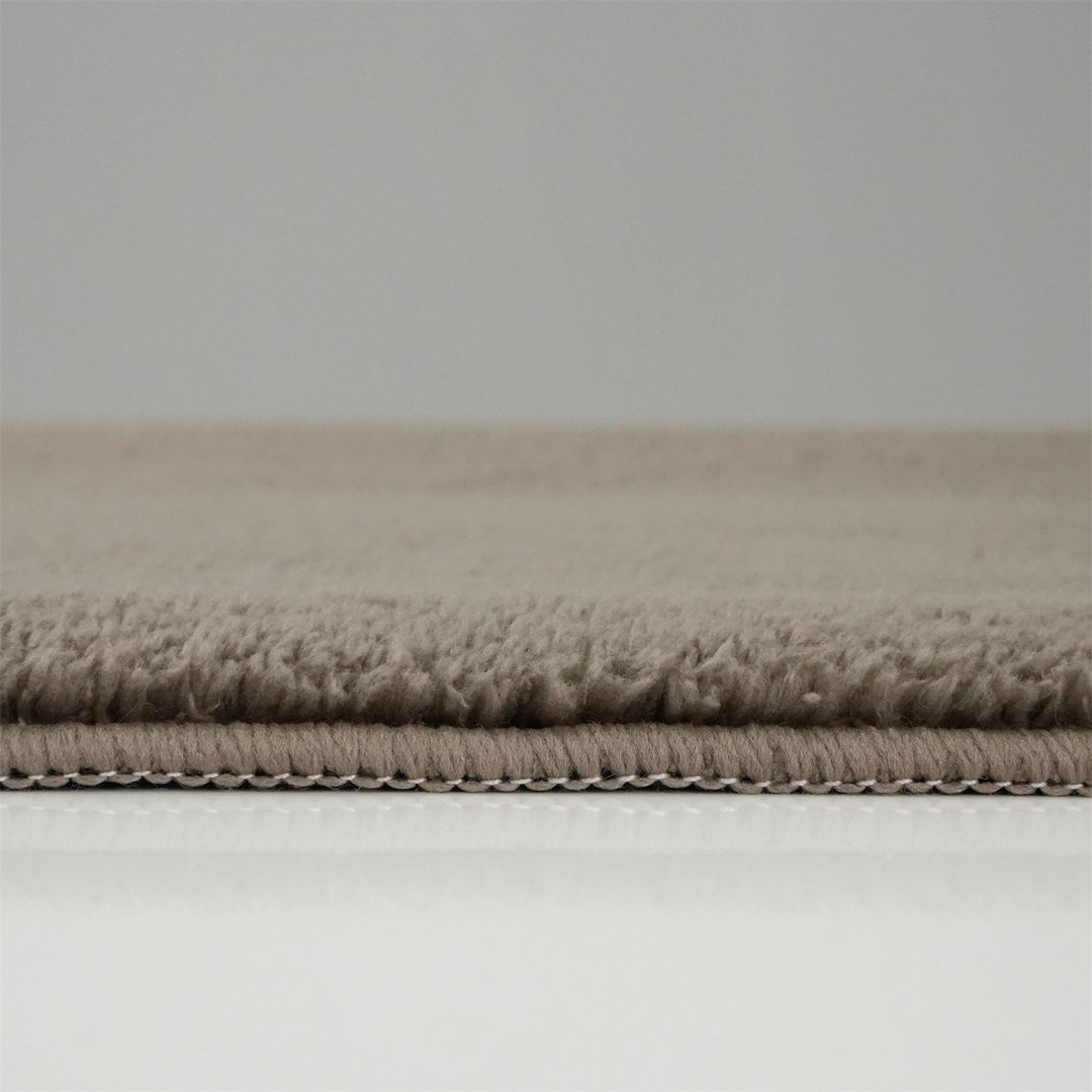 Washmellow light brown washable rug, side view of the low pile and edge at floor level | The Rugs