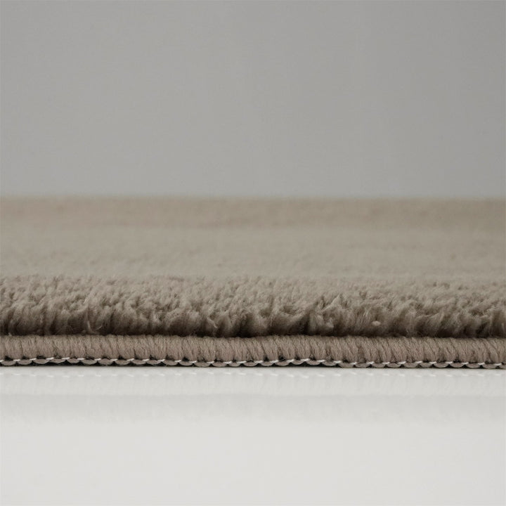 Washmellow light brown washable rug, side view of the low pile and edge at floor level | The Rugs