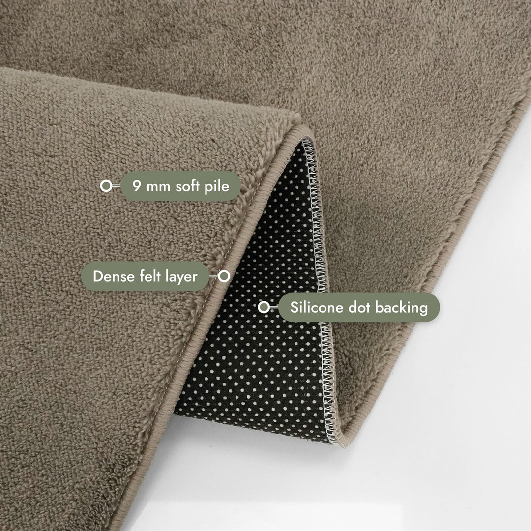 Washmellow light brown washable rug, folded corner showing the pile, felt layer and backing | The Rugs