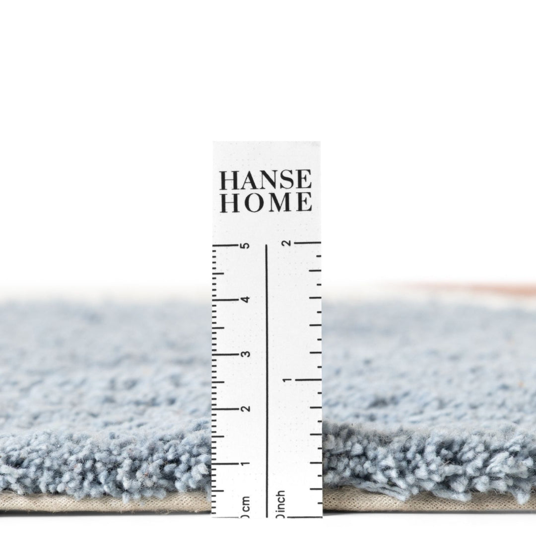 Gray rug with a ruler for scale and 'HANSE HOME' branding.