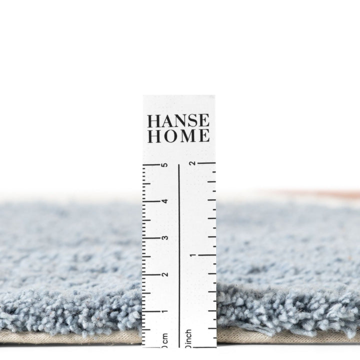 Gray rug with a ruler for scale and 'HANSE HOME' branding.
