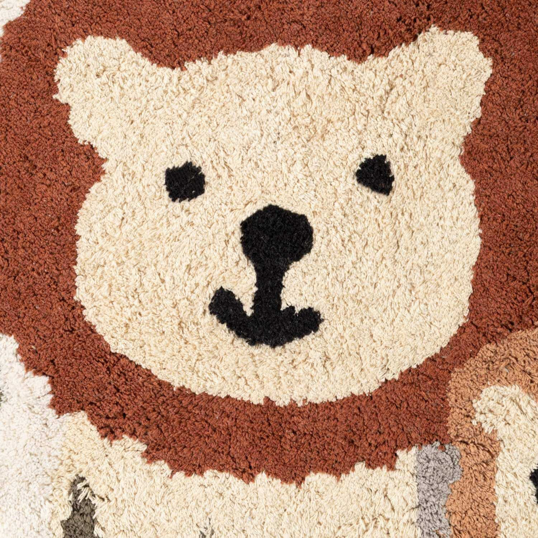Close-up of a rug with a bear face design.