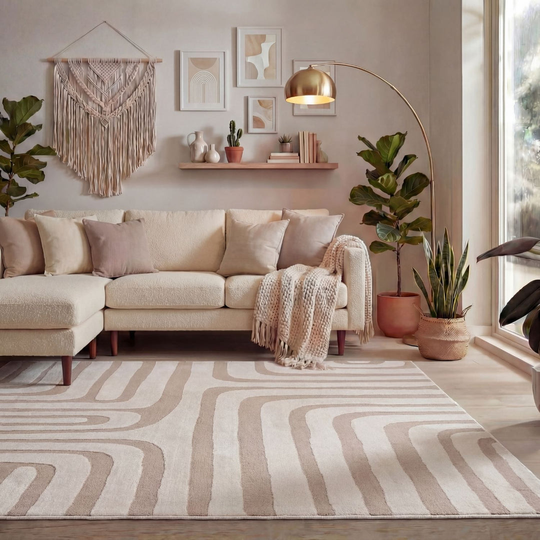 Cozy living room with a beige sectional sofa, decorative rug, and plants.