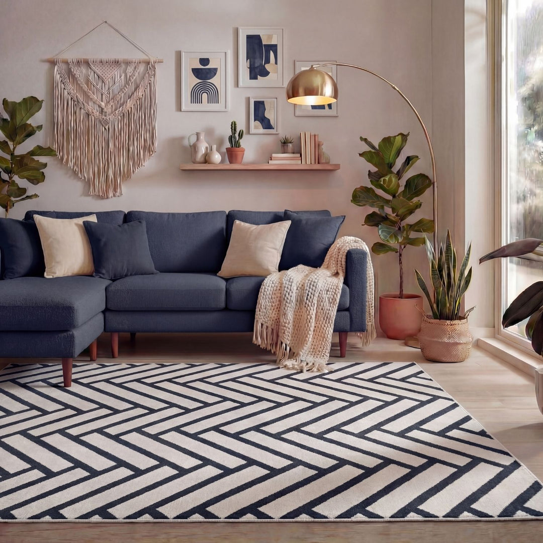 Modern living room with a blue sectional sofa, geometric rug, and decorative elements.