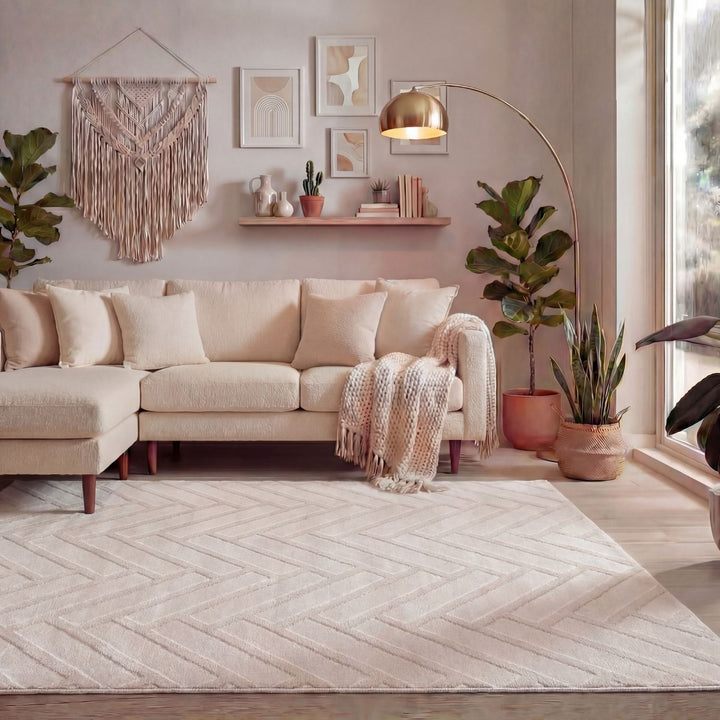 Cozy living room with a beige sectional sofa, decorative plants, and wall art.