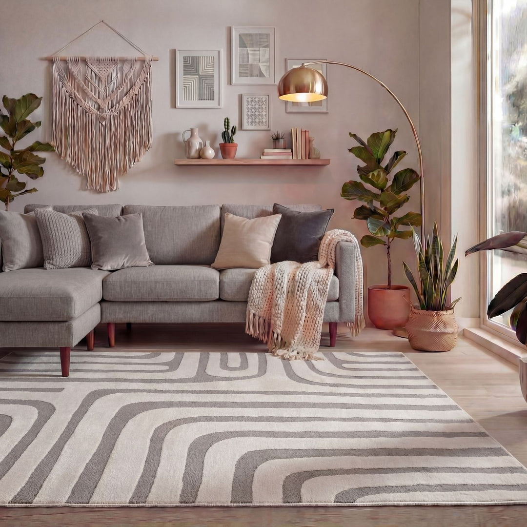 Living room with a gray sectional sofa, patterned rug, and decorative elements.