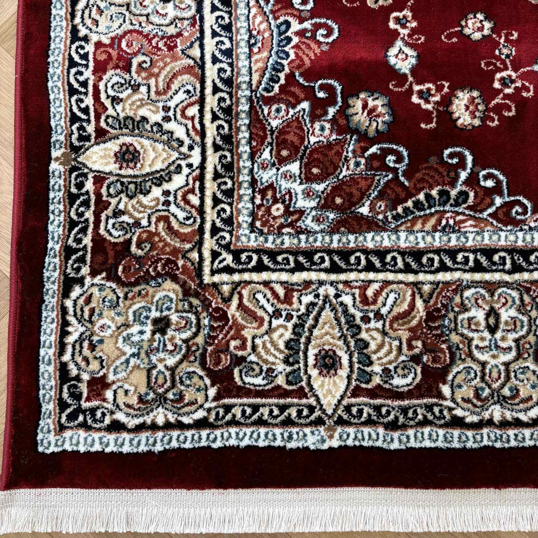 Decorative rug with intricate patterns on a wooden floor