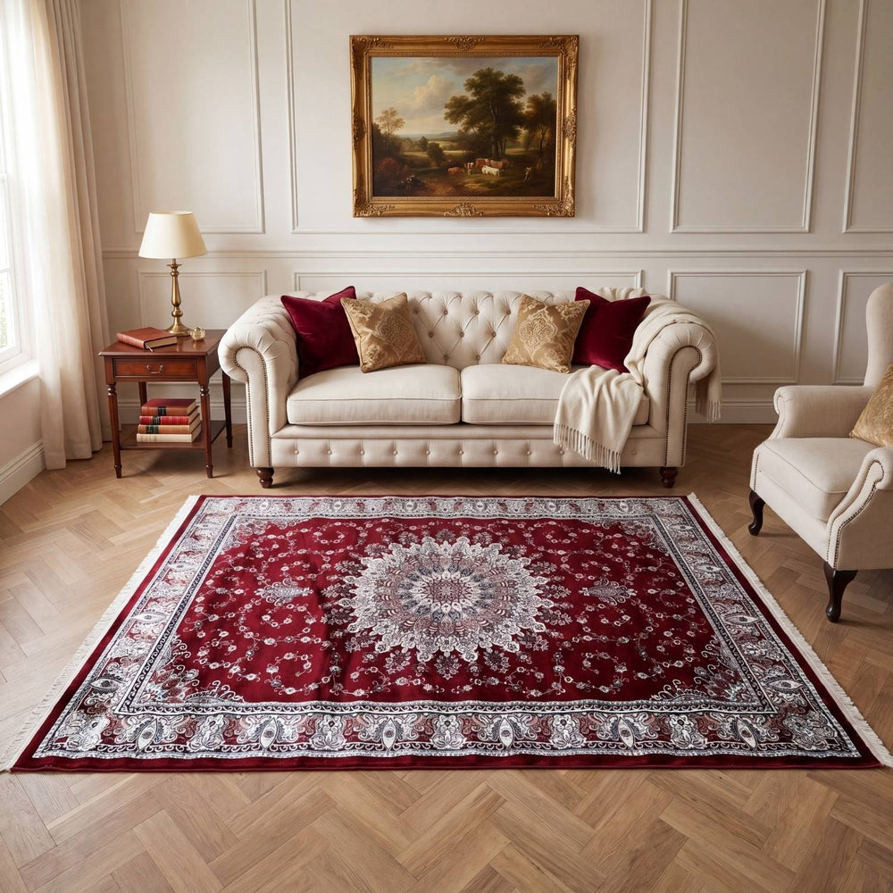 Living room with a red patterned rug, beige sofa, and armchair.