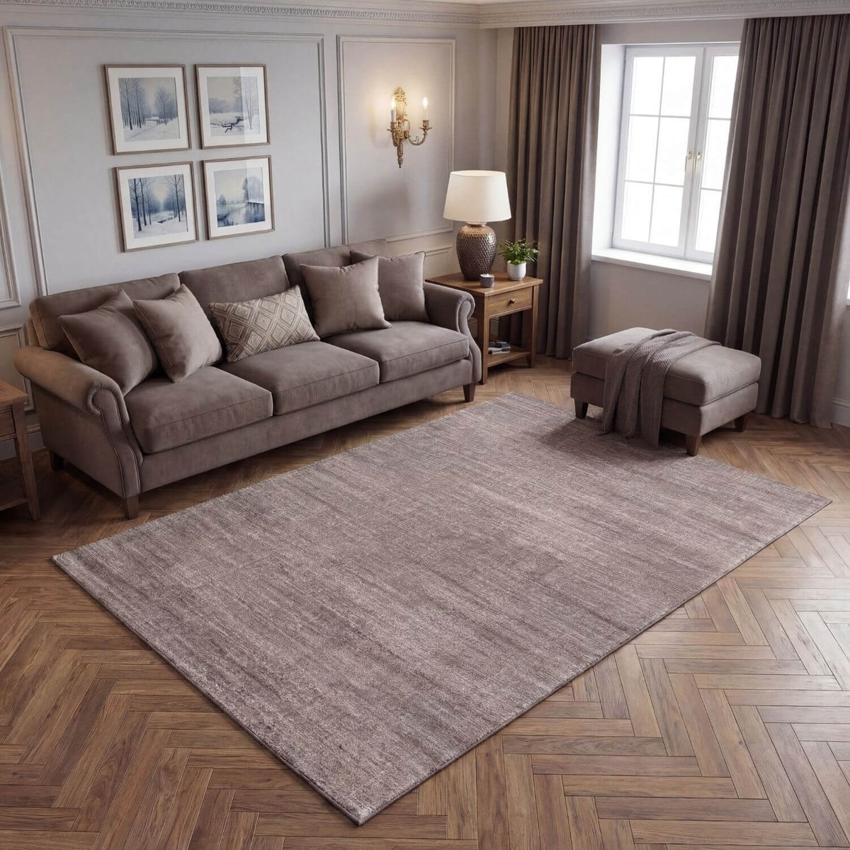 Living room with a grey sofa, rug, and decor elements.