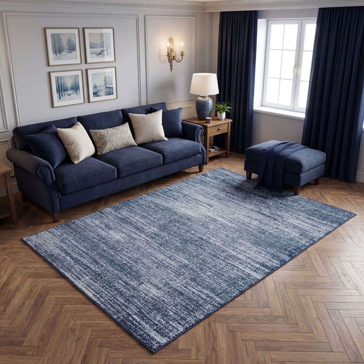 Living room with a blue sofa, rug, and decor elements.