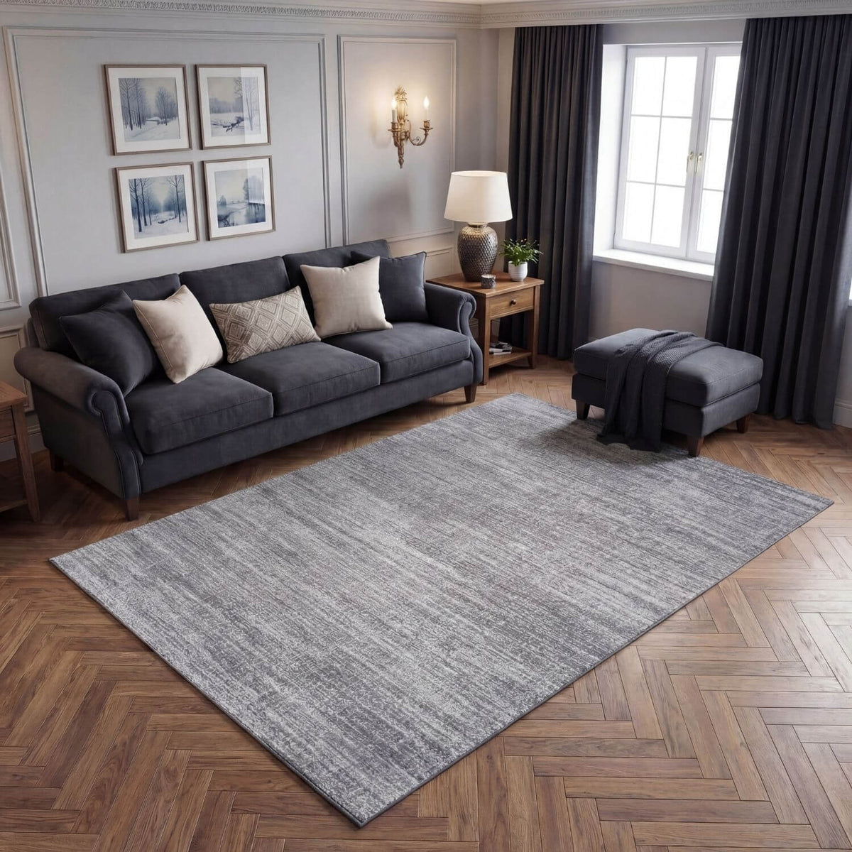 Living room with a grey sofa, rug, and decorative elements.
