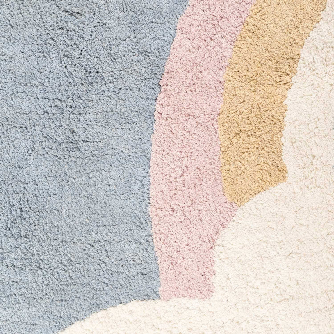 Close-up of a textured rug with pastel colors
