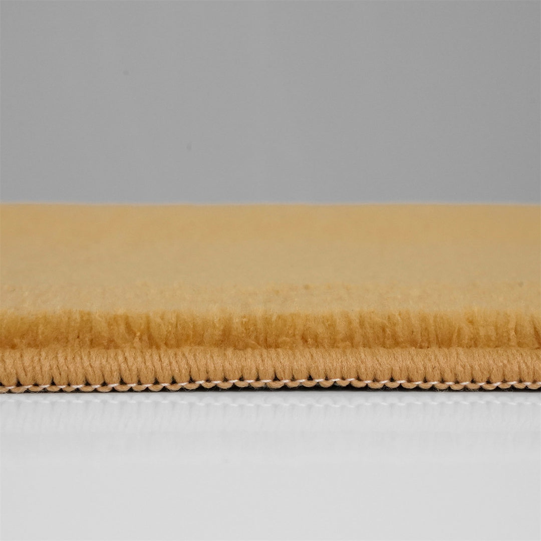 Washmellow ochre washable rug, side view of the low pile and edge at floor level | The Rugs