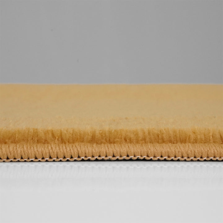 Washmellow ochre washable rug, side view of the low pile and edge at floor level | The Rugs