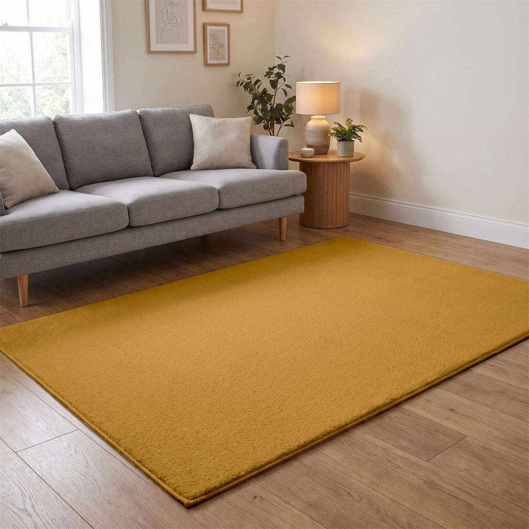 Washmellow ochre washable rug in a living room with a grey sofa and oak floor | The Rugs