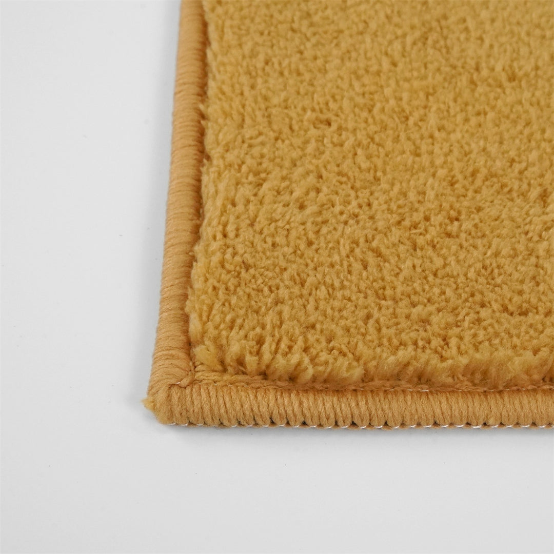 Washmellow ochre washable rug, close-up of the corner and bound edge | The Rugs