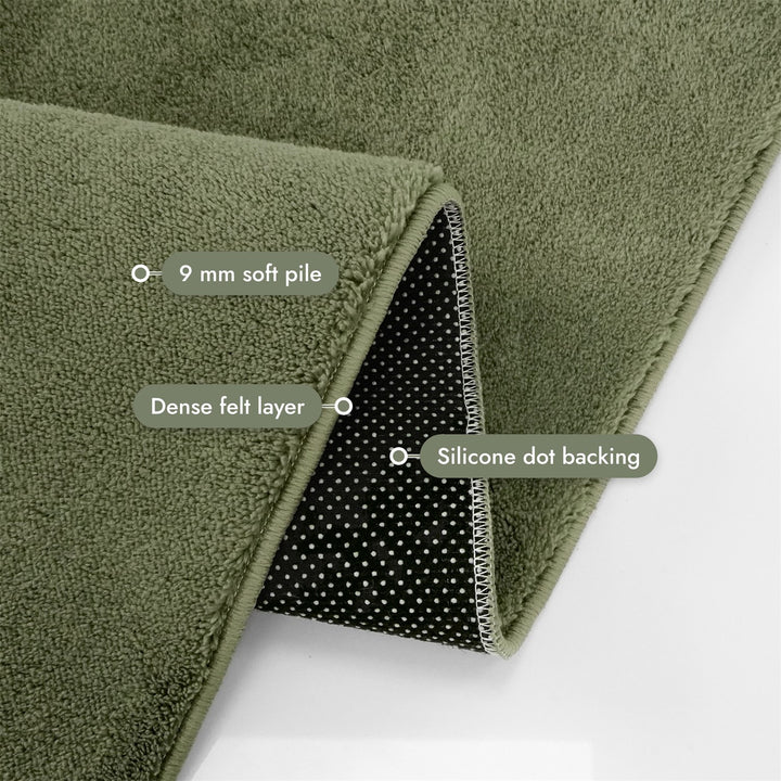Washmellow olive green washable rug, folded corner showing the pile, felt layer and backing | The Rugs