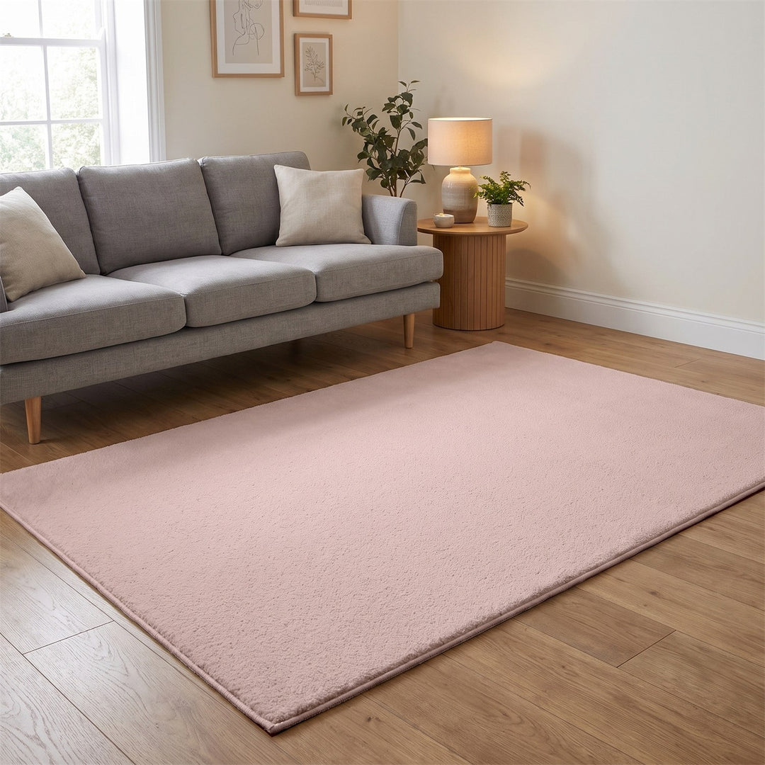 Washmellow pink washable rug in a living room with a grey sofa and oak floor | The Rugs