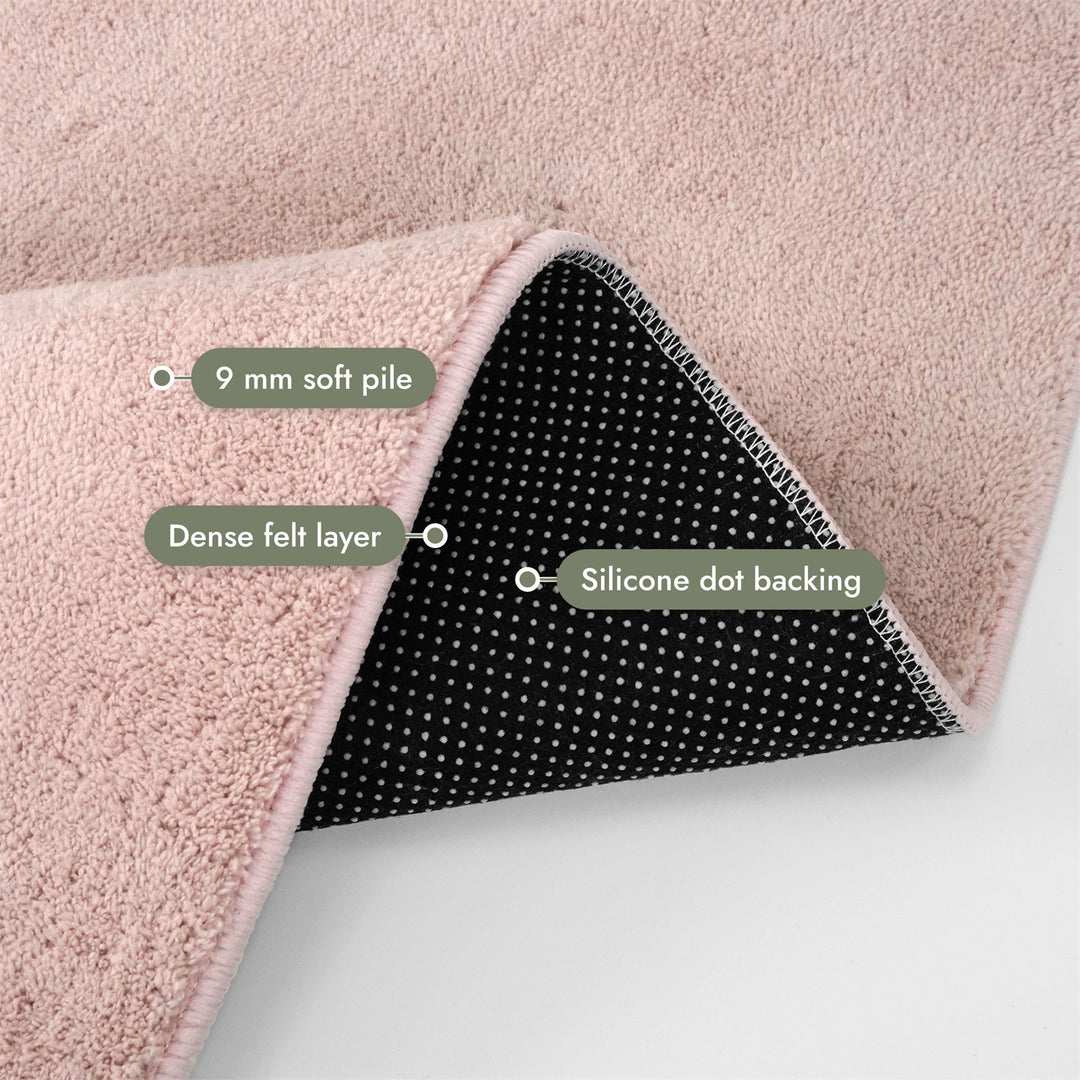 Washmellow pink washable rug, folded corner showing the pile, felt layer and backing | The Rugs