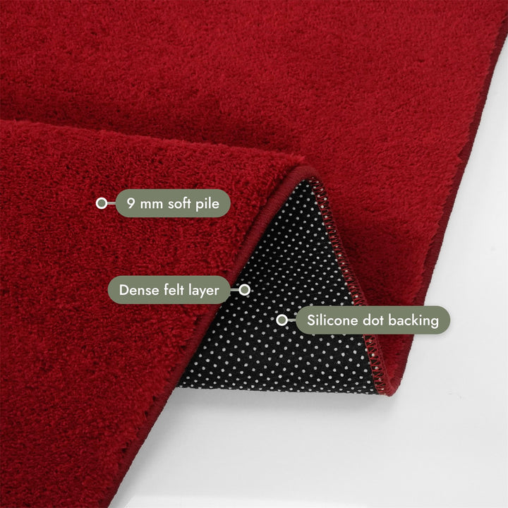 Washmellow red washable rug, folded corner showing the pile, felt layer and backing | The Rugs