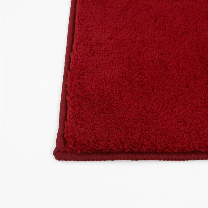 Washmellow red washable rug, close-up of the corner and bound edge | The Rugs