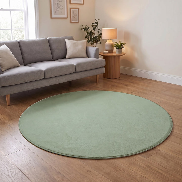 Washmellow sage green round washable rug in a living room | The Rugs