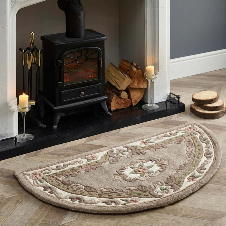 Decorative half-circle rug in front of a lit wood stove with candles and firewood.