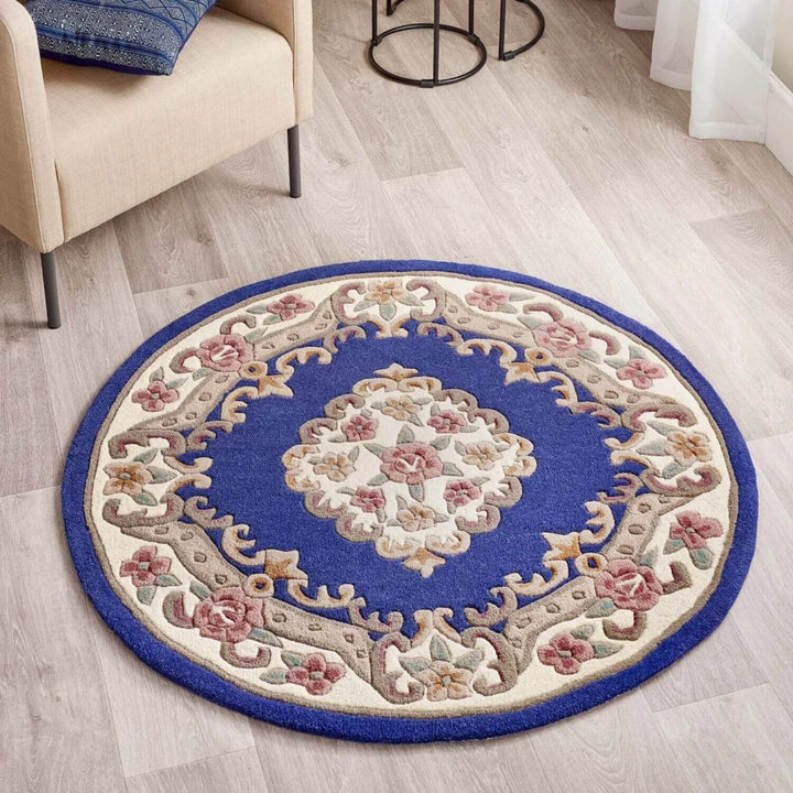 Round decorative rug with floral patterns on a wooden floor