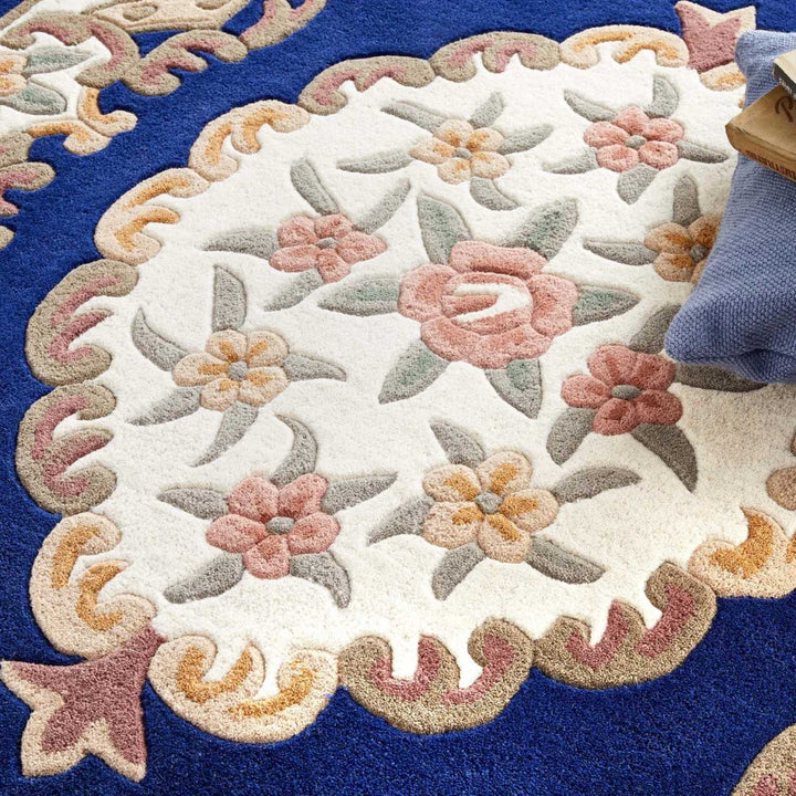 Close-up of a floral-patterned rug with a blue border