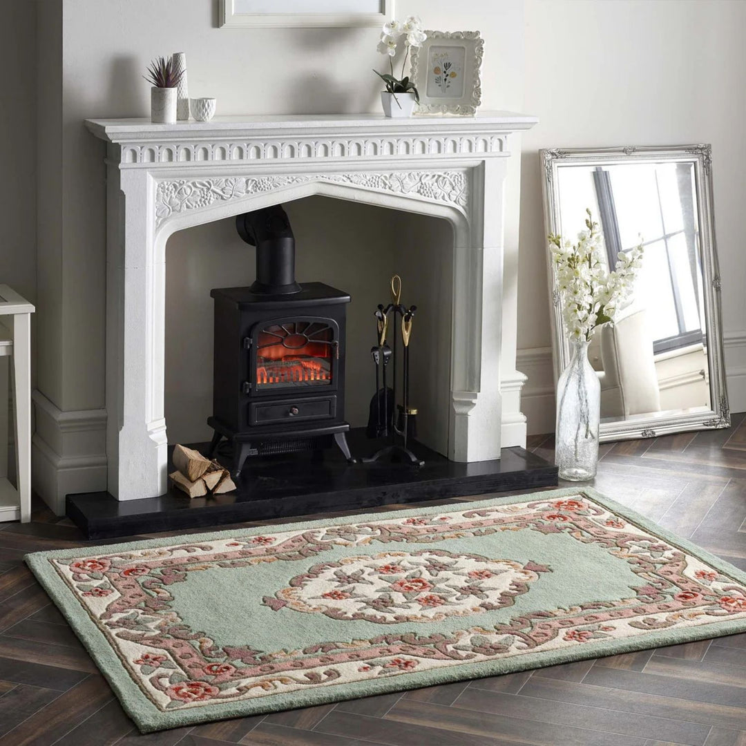Decorative rug in front of a white fireplace with a black stove.